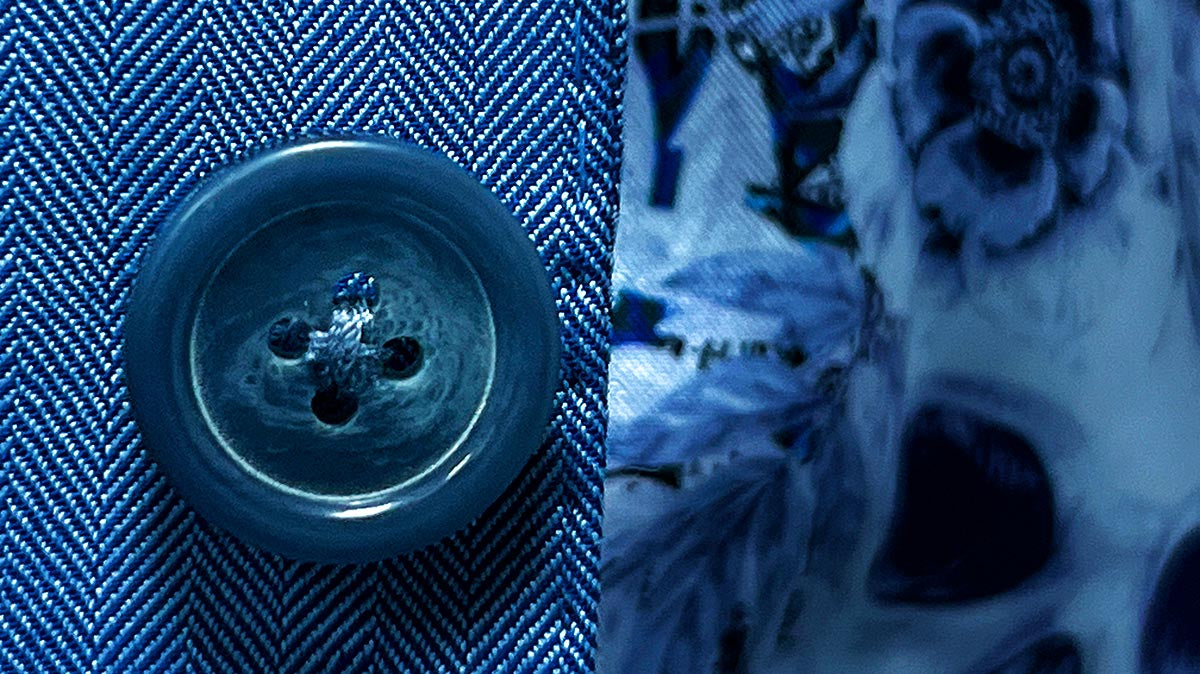 Close-up of various button types used in men's custom suits, showcasing materials like Mother of Pearl and Horn