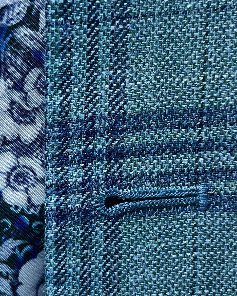Detailed view of the men's sportcoat's buttonhole stitching.