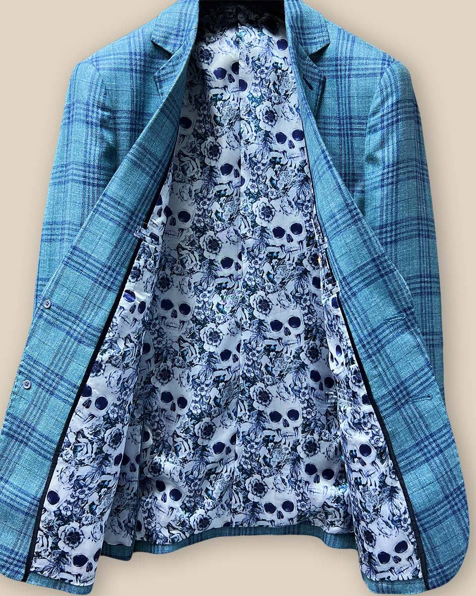 Full view of the men's sportcoat's interior, highlighting the intricate blue and white rose and skull fancy lining.