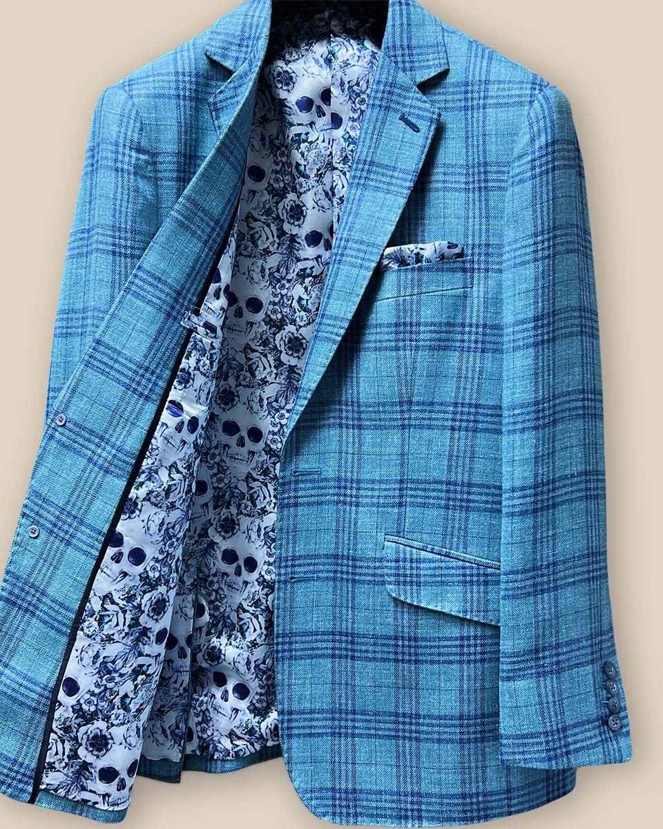 Inside view of the men's sportcoat's right side, showcasing the blue and white rose and skull fancy lining and interior pockets.