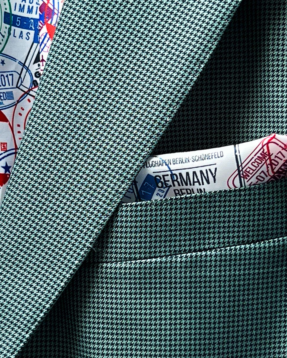 Functional sleeve buttonholes on a hunter green sportcoat.