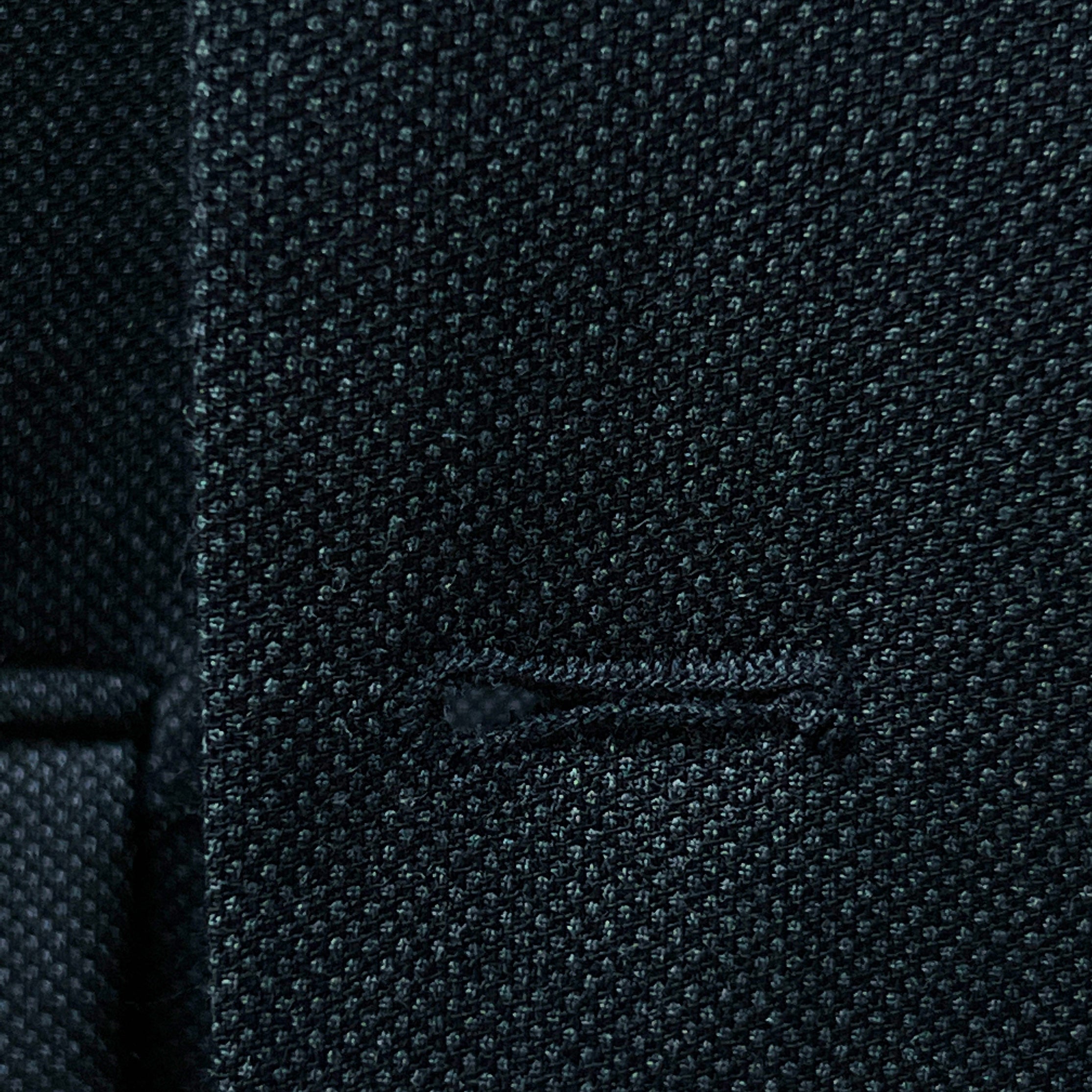 Dark grey birdseye custom suit, detailed view of the lapel and buttonhole, ideal for online design