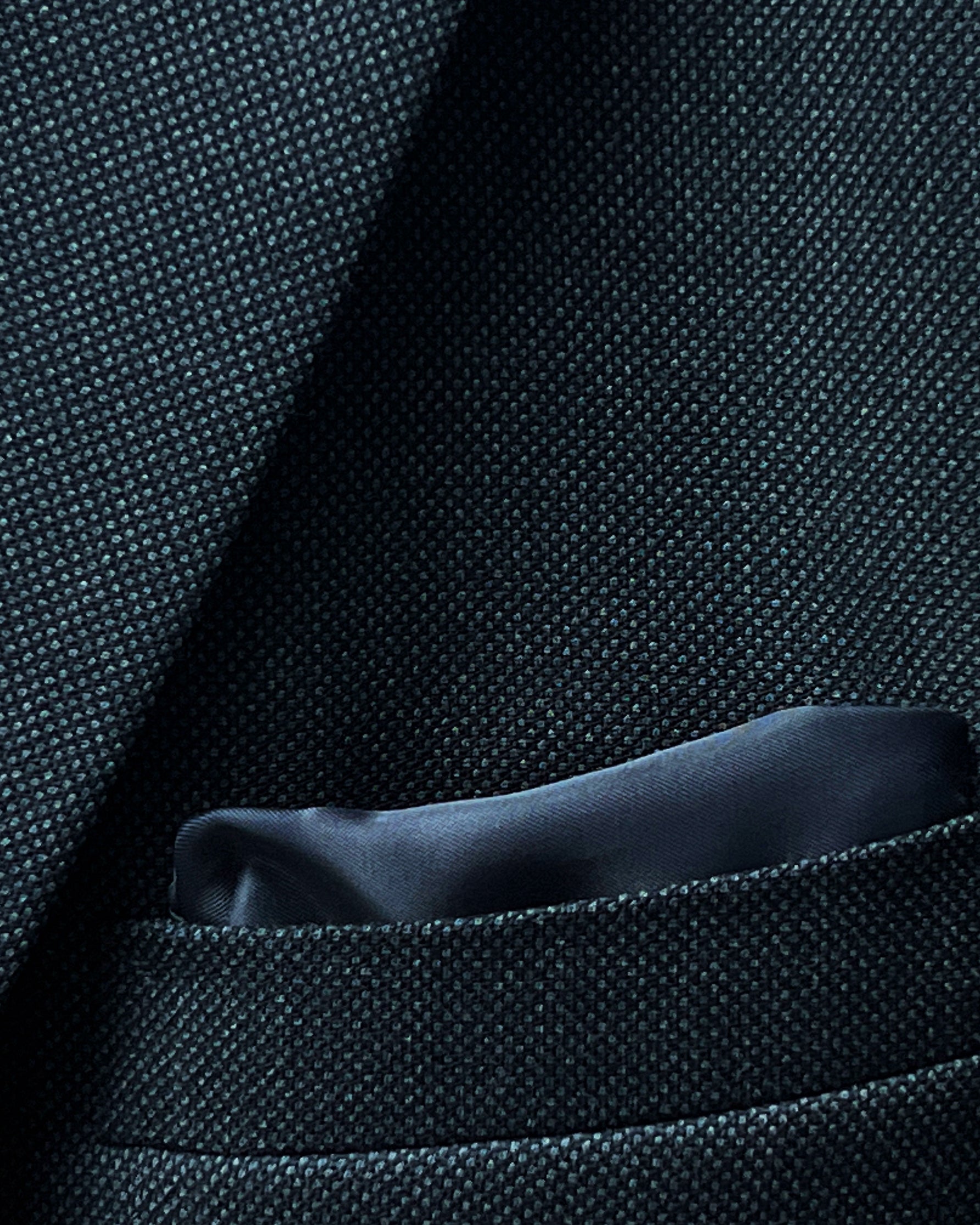 Men's online suit design featuring dark grey birdseye fabric, with a focus on the jacket's inner lining