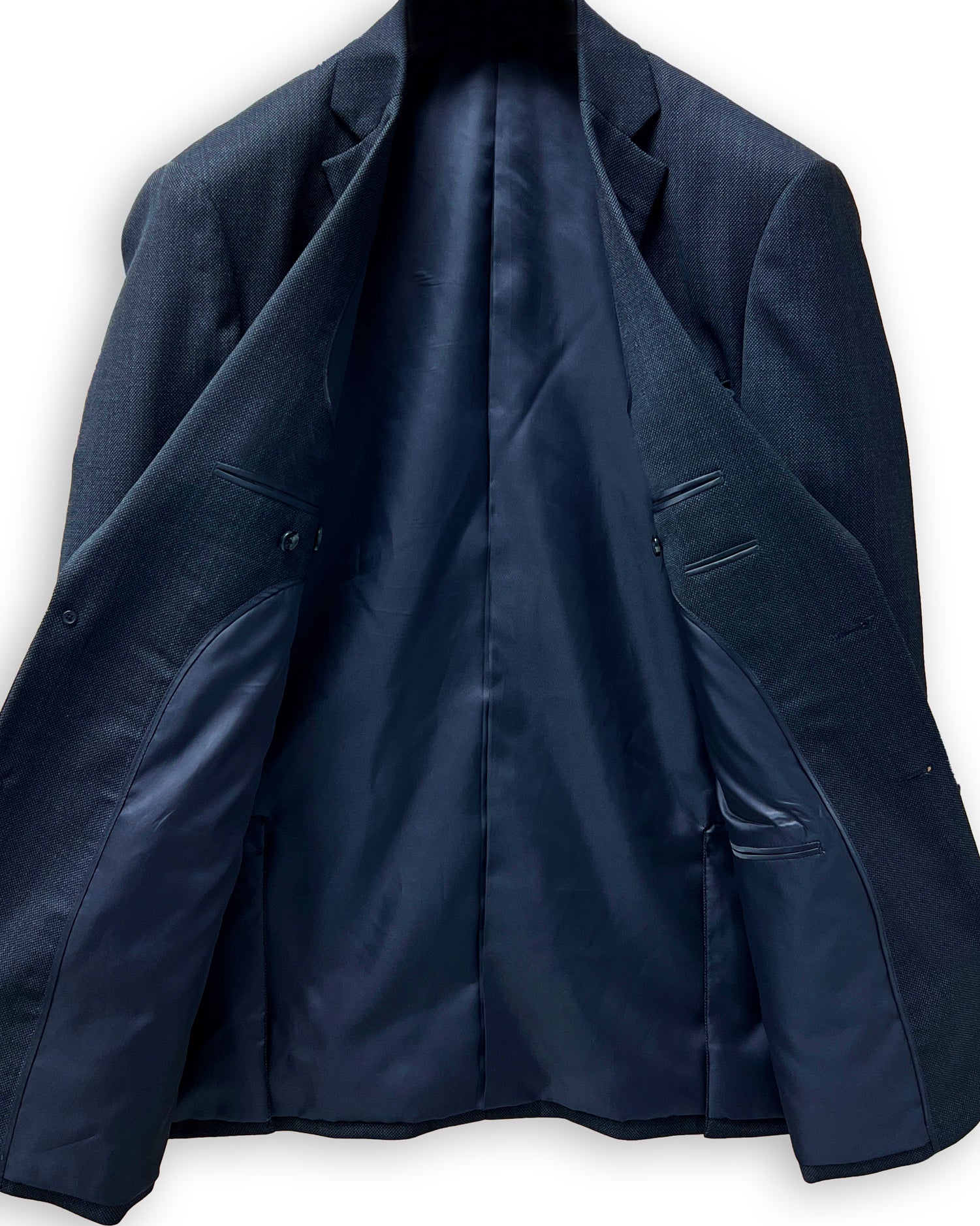 Men's custom tailored birdseye suit, side view highlighting the precise fit for work