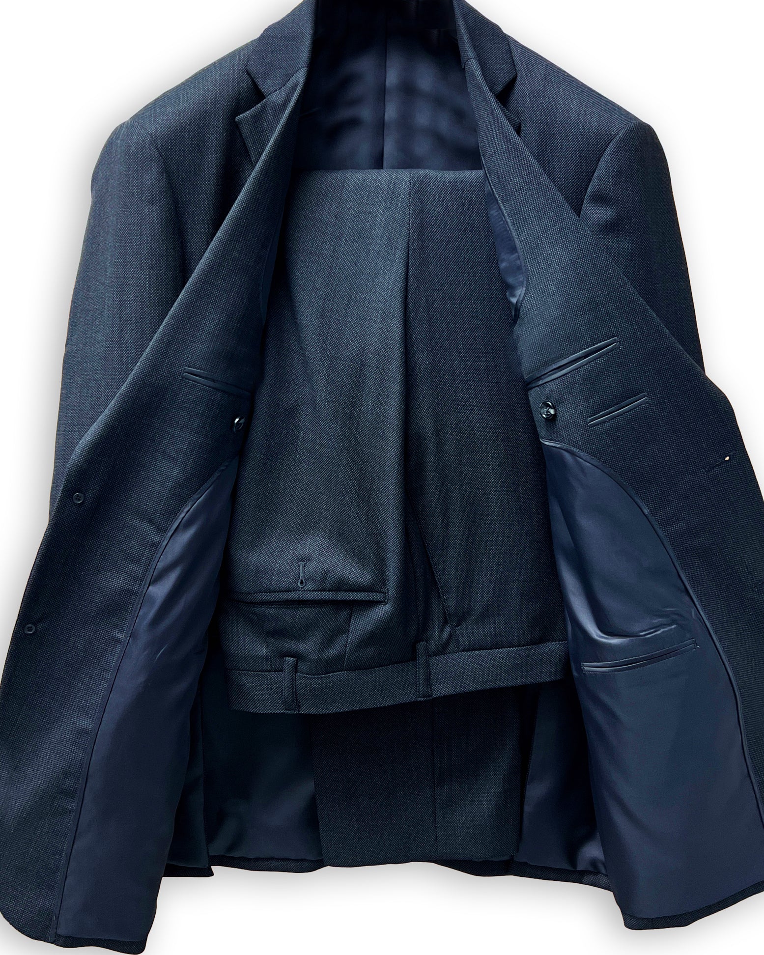 Men's custom tailored birdseye suit, side view highlighting the precise fit for work