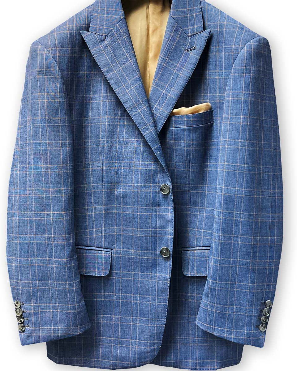 Lapel buttonhole detail on a stone blue suit with tan windowpane plaid.