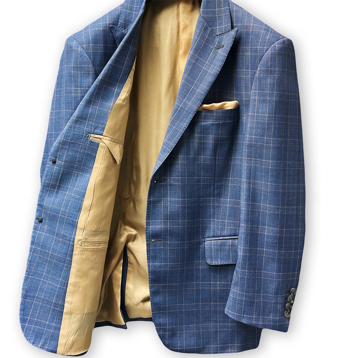 Pick stitching details on the trousers of a stone blue suit.