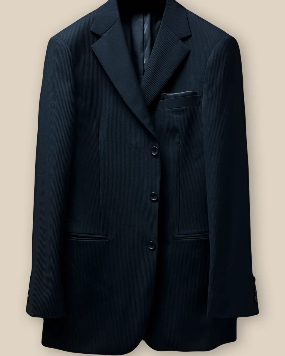 Detailed image of the jacket button panel with black horn buttons and precise buttonholes.