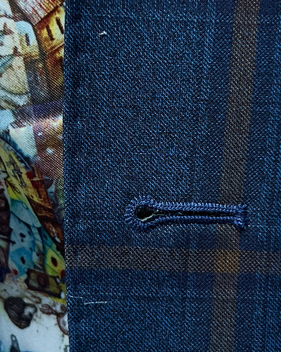 Detailed view of the buttonhole stitching, highlighting the brown accent color on the blue with bronze windowpane fabric.