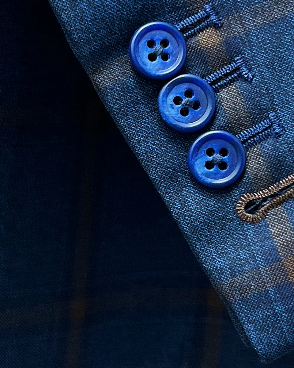 Close-up of the functional sleeve buttonholes with brown accent stitching.