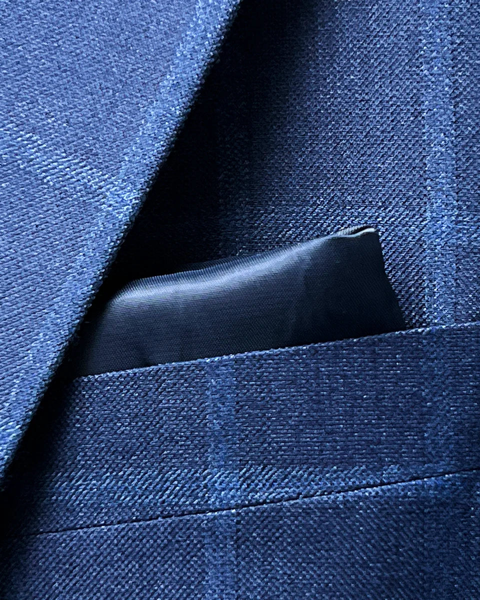 Creative pocket square integration in the Indigo Blue Windowpane sport coat, showing complementary fabric accent