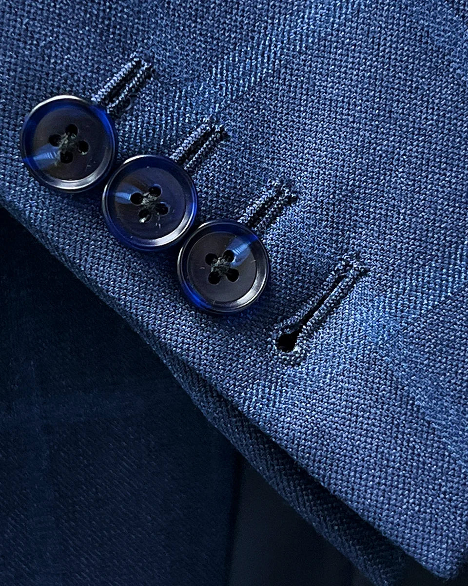 Detail shot of working sleeve buttonholes on the Indigo Blue Windowpane sport coat, a hallmark of bespoke tailoring