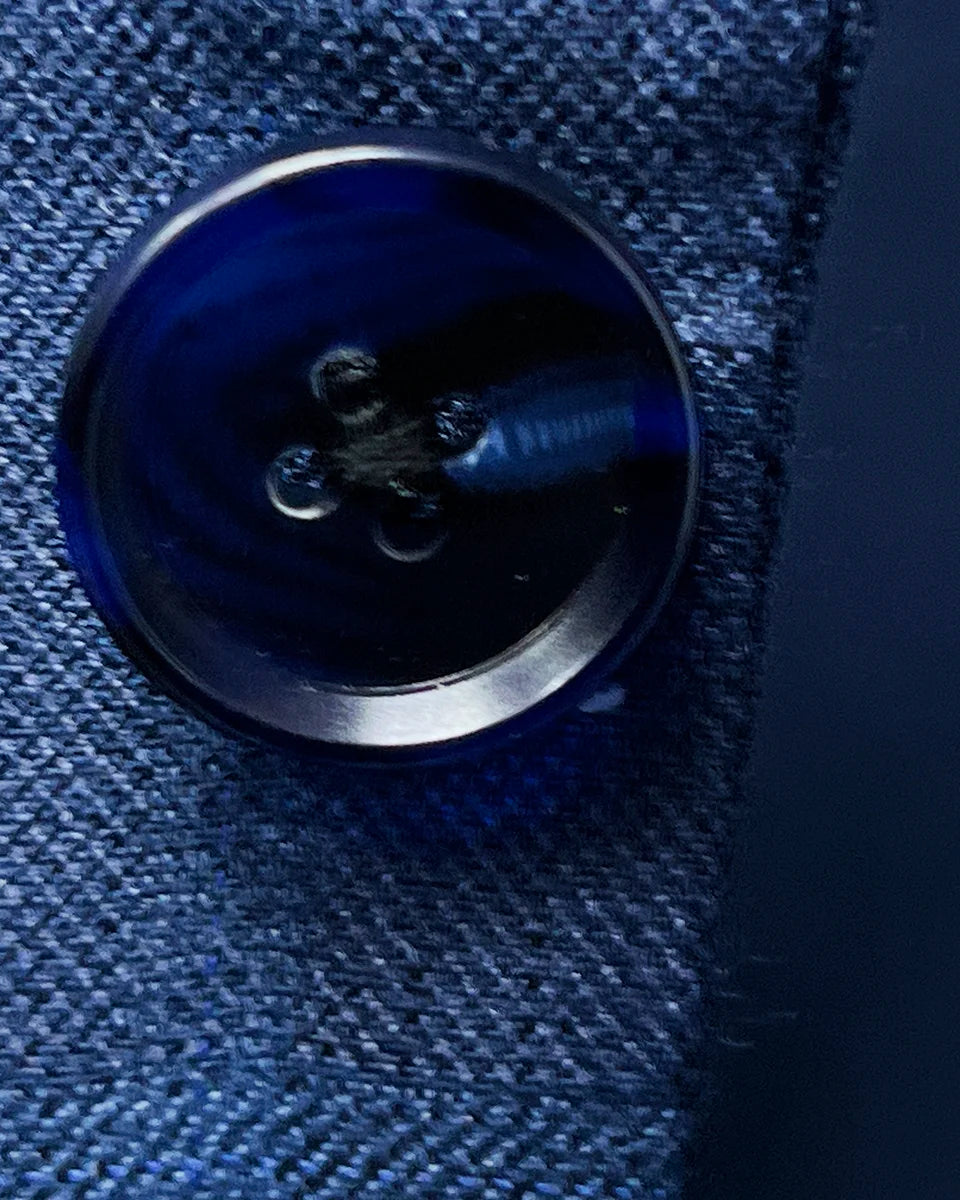 Detailed close-up of the natural variations in the navy horn buttons on the Indigo Blue Windowpane sport coat