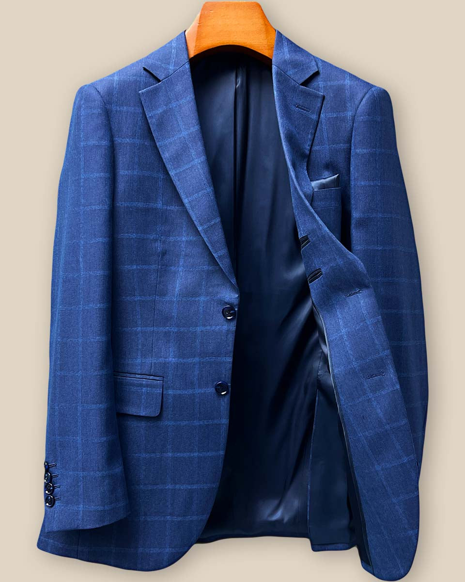 Interior left panel of the Indigo Blue Windowpane blazer revealing pocket construction and midnight blue bemberg lining