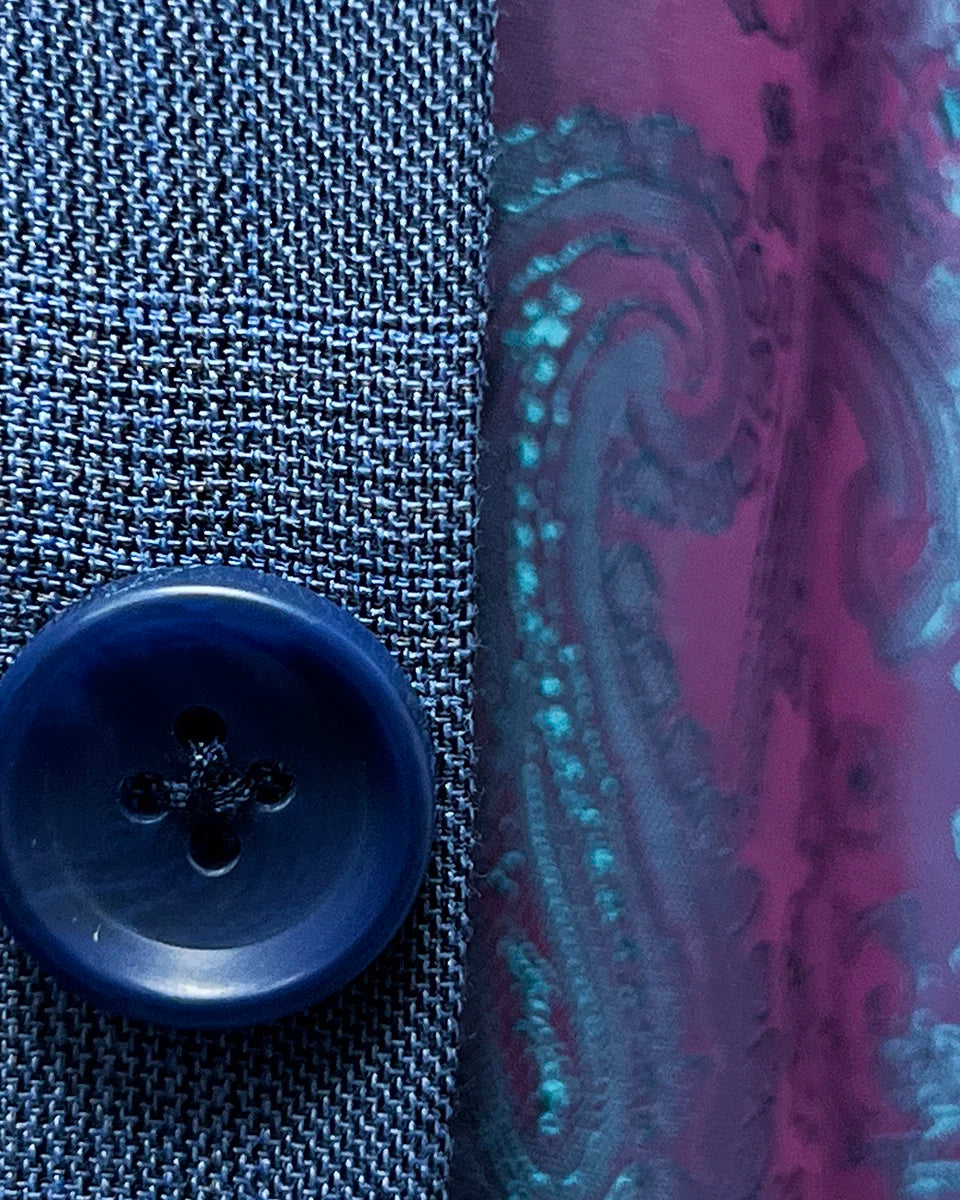 Detailed view of the medium blue horn marble buttons on the suit jacket, emphasizing their quality and style.