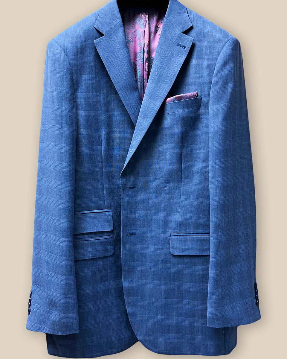 Close-up view of the jacket buttonhole panel on a medium blue Prince of Wales glen plaid suit, highlighting the quality craftsmanship.