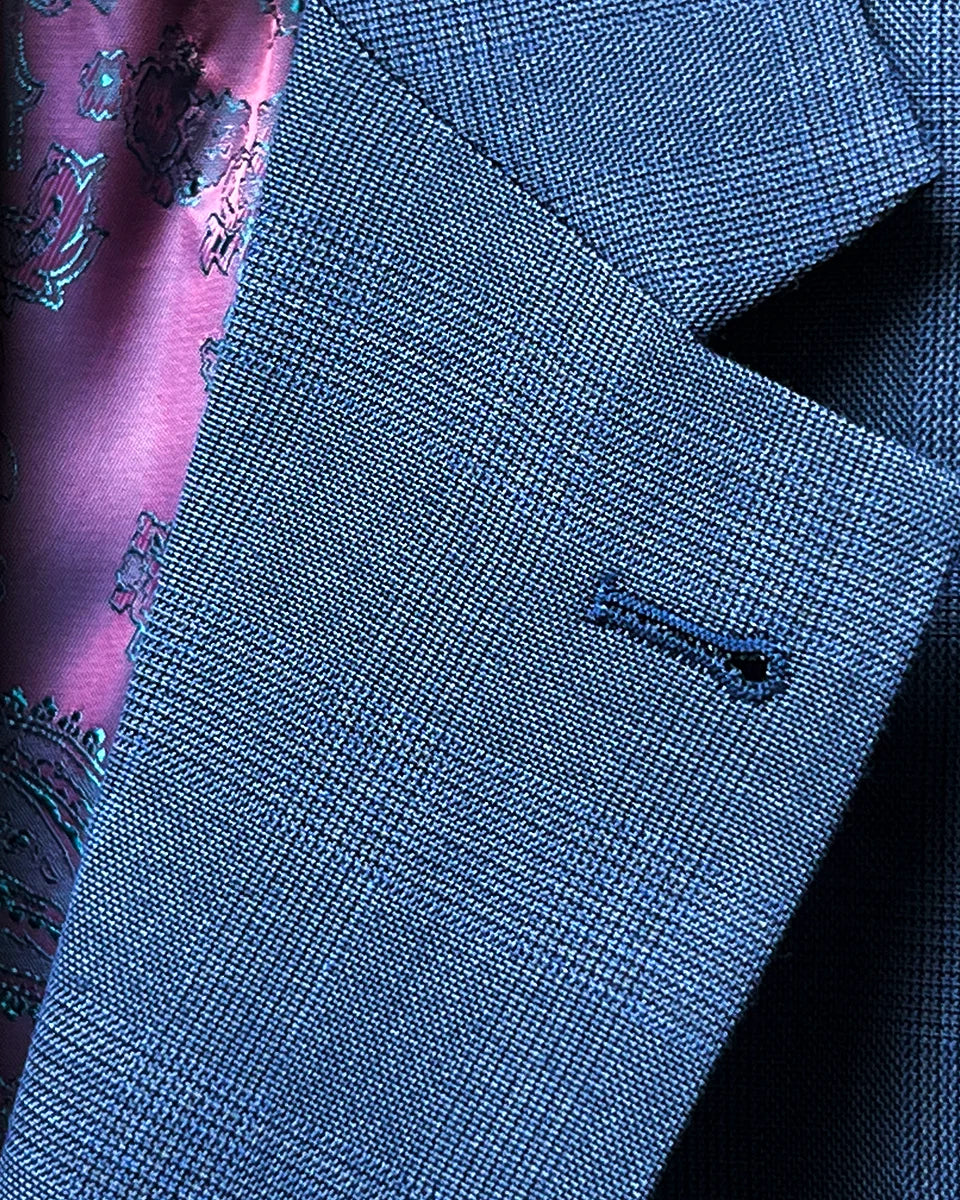 Close-up view of the notch lapel on the suit jacket, showcasing its classic style.