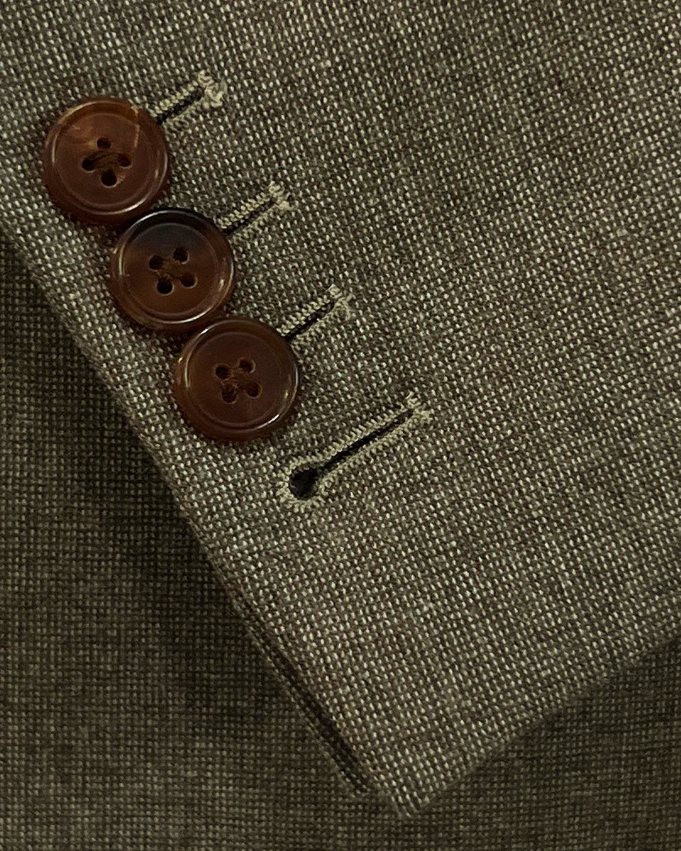 View of the functional sleeve buttonholes on the Westwood Hart brown nailhead men's suit jacket, showcasing the precise craftsmanship.