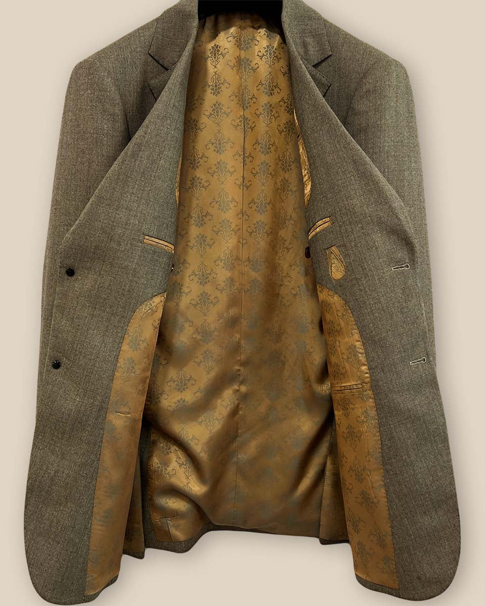 Detailed look at the gold patterned lining inside the Westwood Hart brown nailhead men's suit jacket, highlighting its luxurious finish.