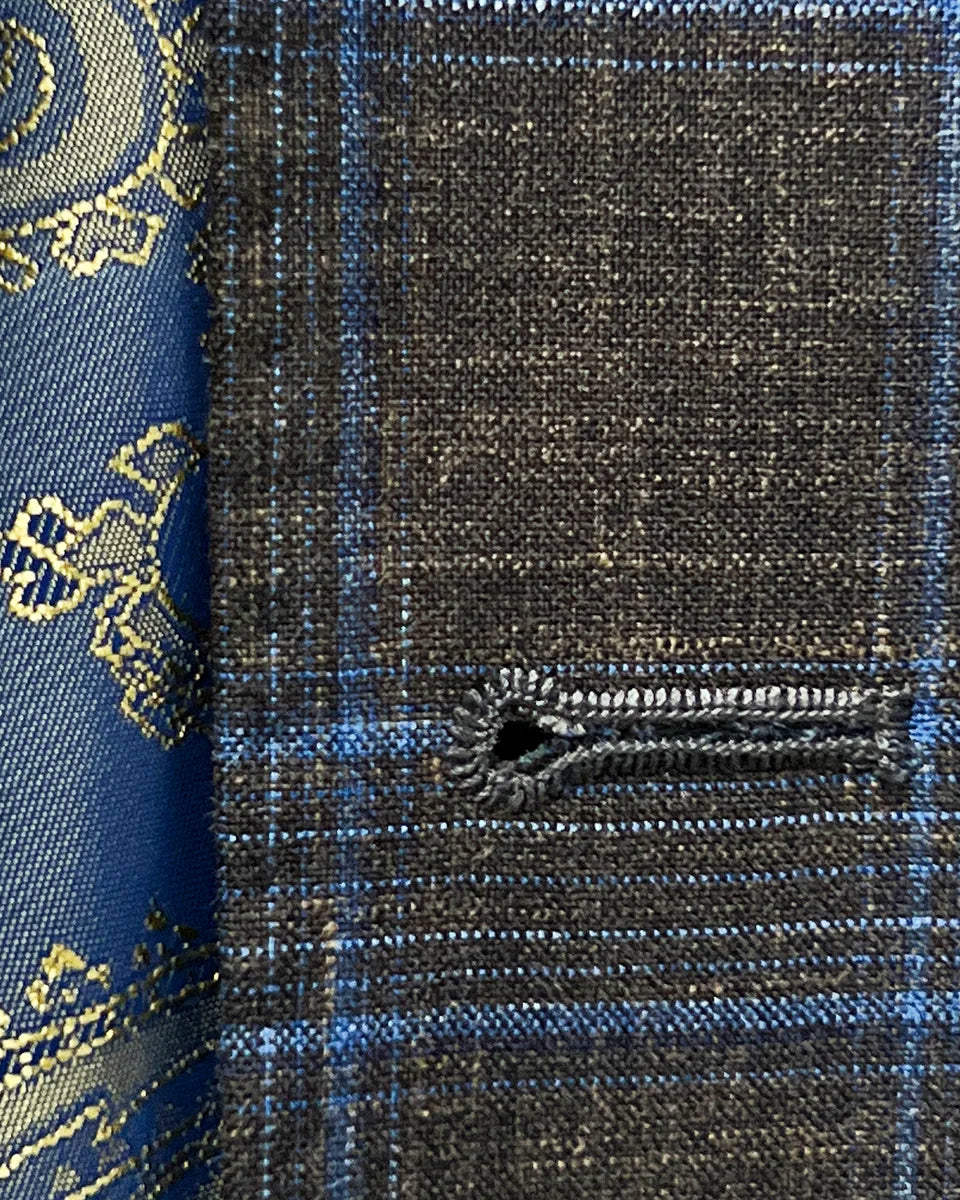 Close-up of the buttonhole stitching showcasing the hand pick stitching on the chocolate brown with blue windowpane plaid fabric.