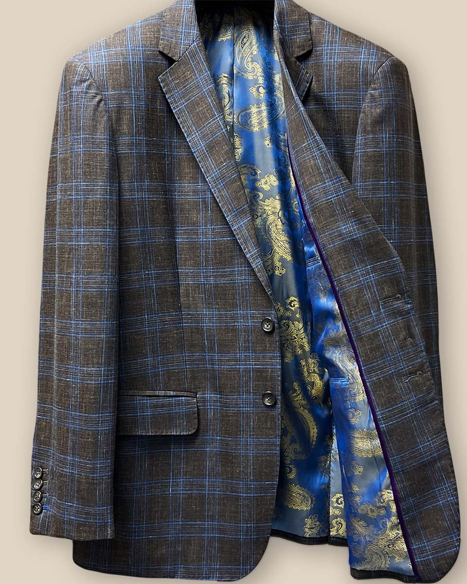 Inside view of the left side of the jacket featuring the blue and gold paisley fancy lining and purple contrast piping.