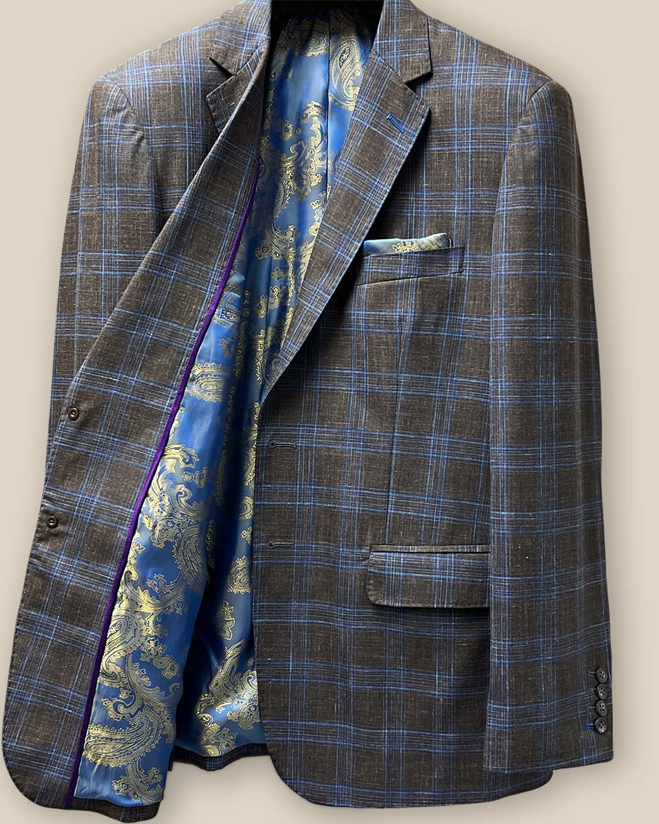 Inside view of the right side of the jacket featuring the blue and gold paisley fancy lining and purple contrast piping.