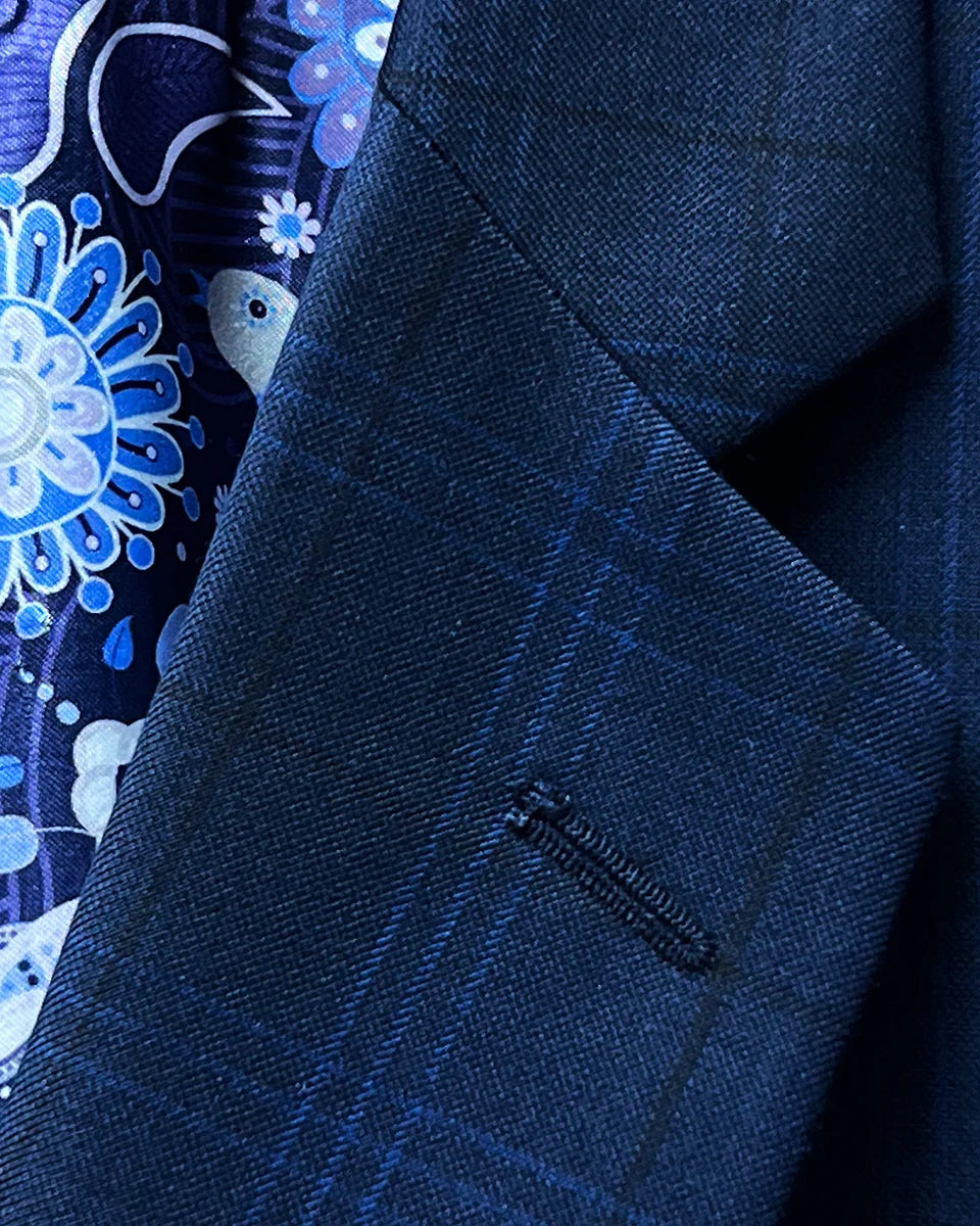 Close-up of the notch lapel on the dark blue windowpane men's sport coat.