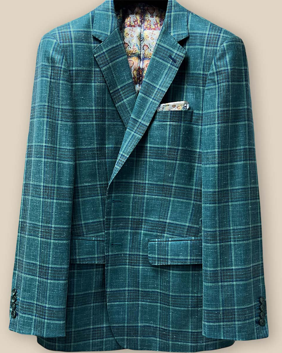 Close-up of the buttonhole panel on a Westwood Hart hunter green with navy and chocolate brown plaid mens sport coat, showcasing the detailed hand pick stitching.