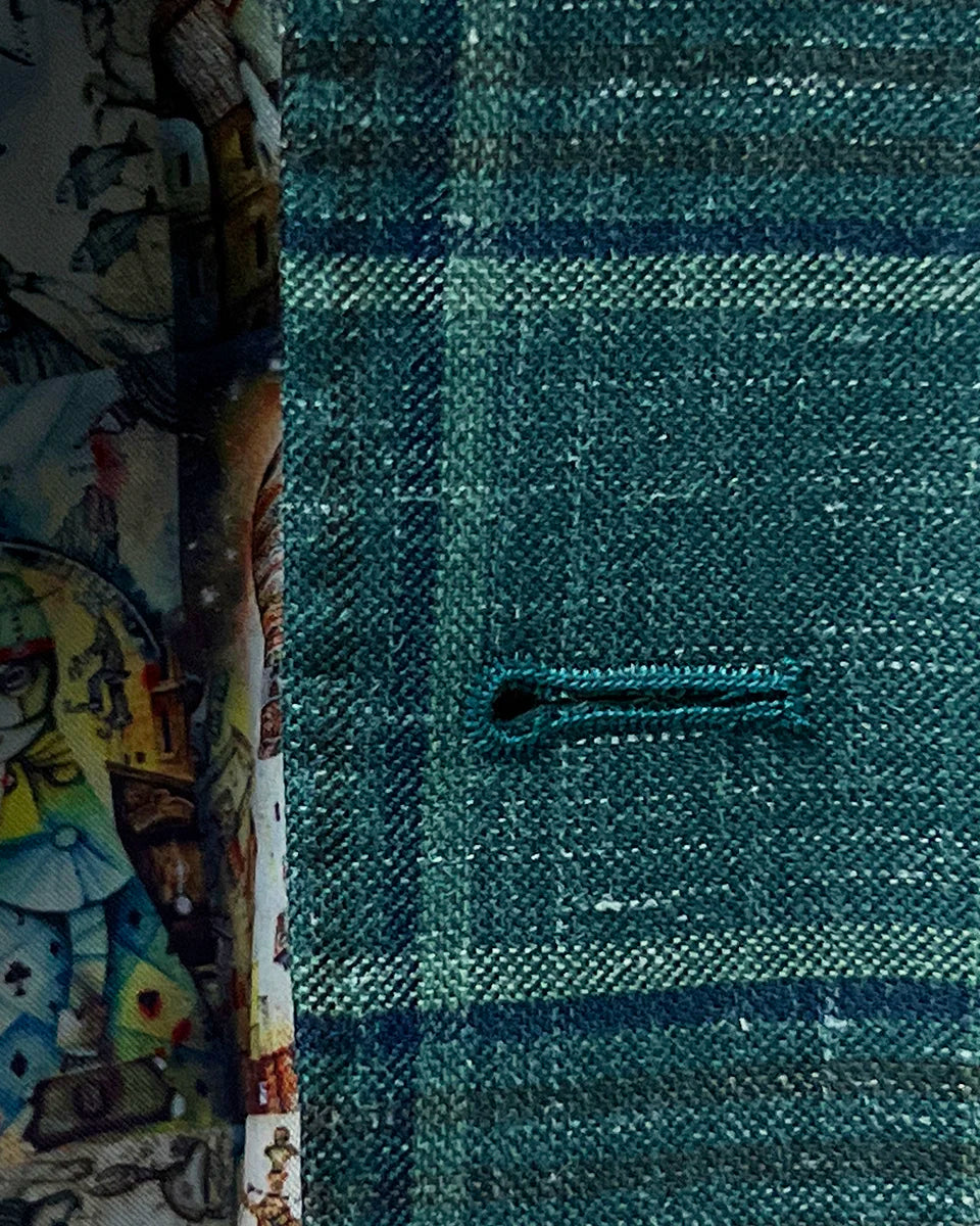 Close-up of the hand pick stitching on the buttonhole of the Westwood Hart hunter green with navy and chocolate brown plaid mens sport coat.