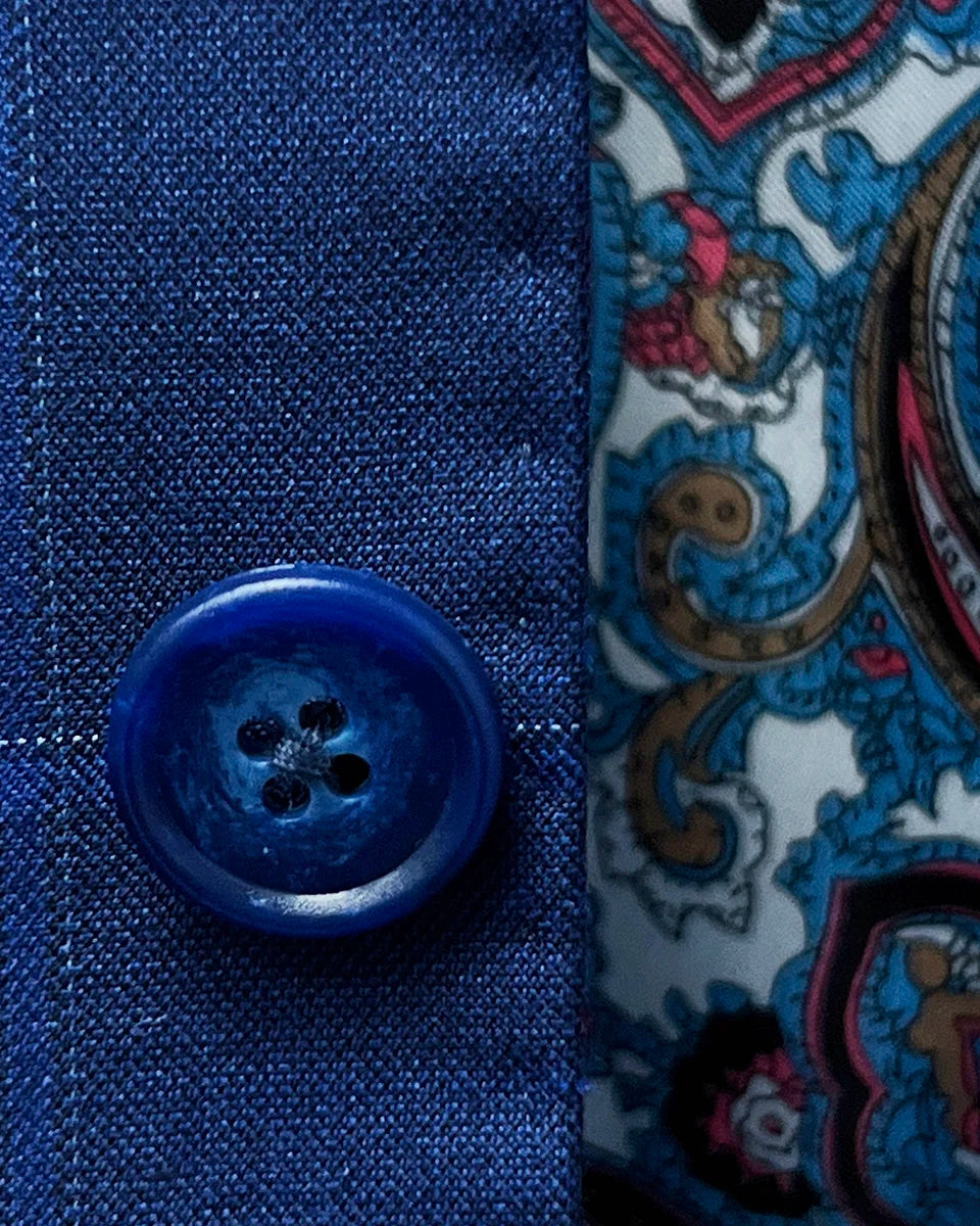 Close-up of the blue marble horn buttons on the royal blue suit with a navy and white windowpane pattern.