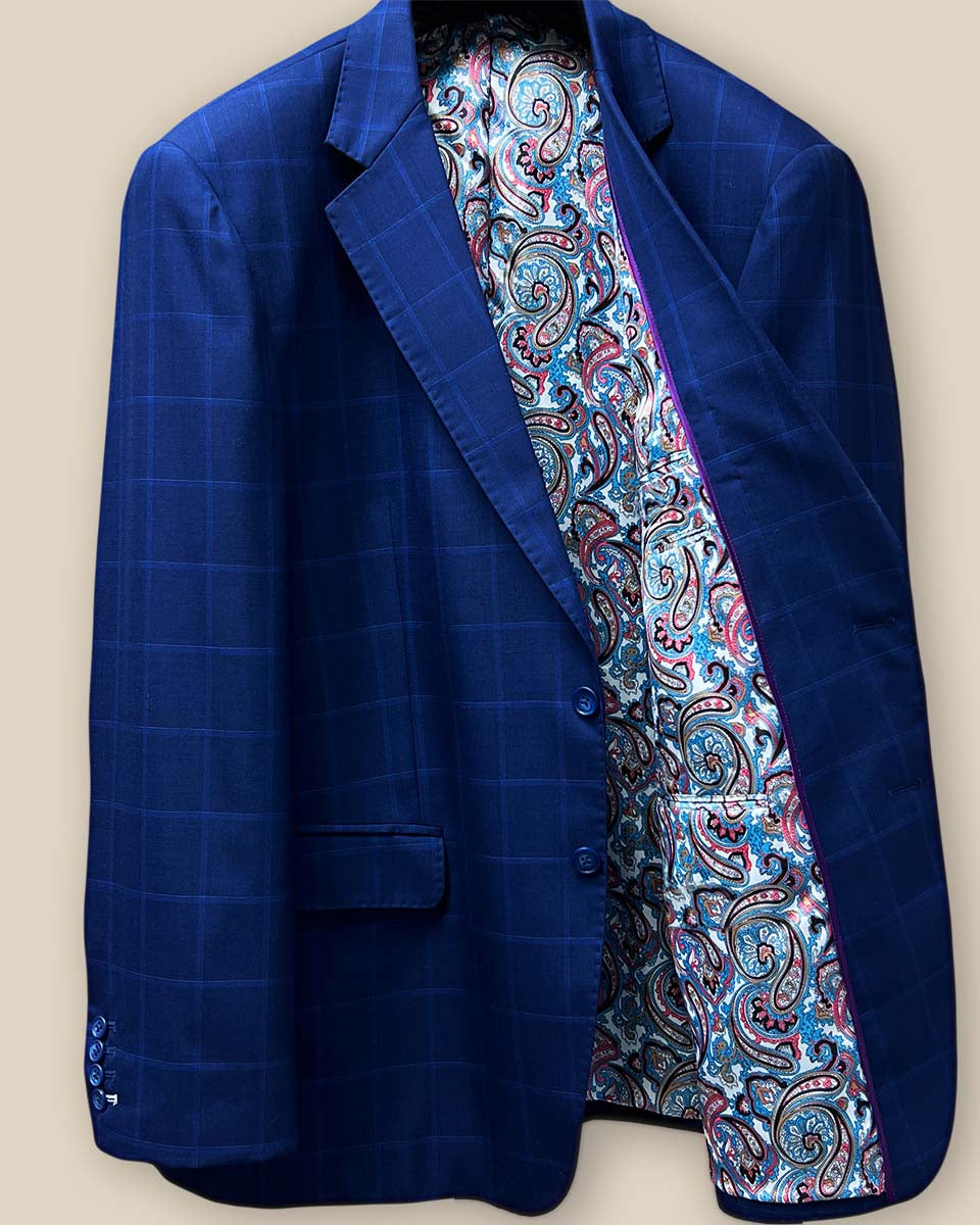 Interior view of the left side of the jacket featuring the multi-color fancy paisley lining and inner purple piping.