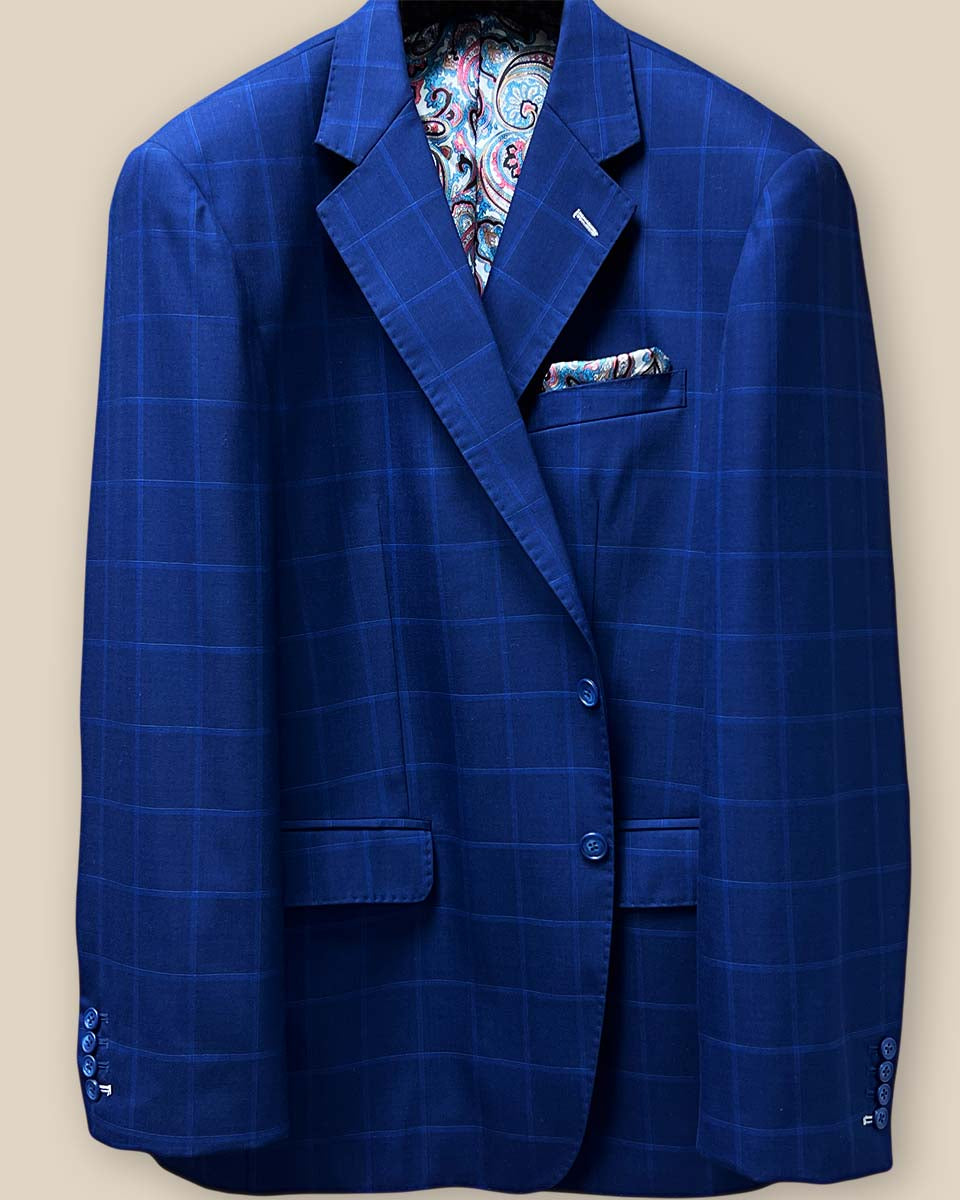 Detailed view of the jacket button panel with blue marble horn buttons on the royal blue fabric with navy and white windowpane design.