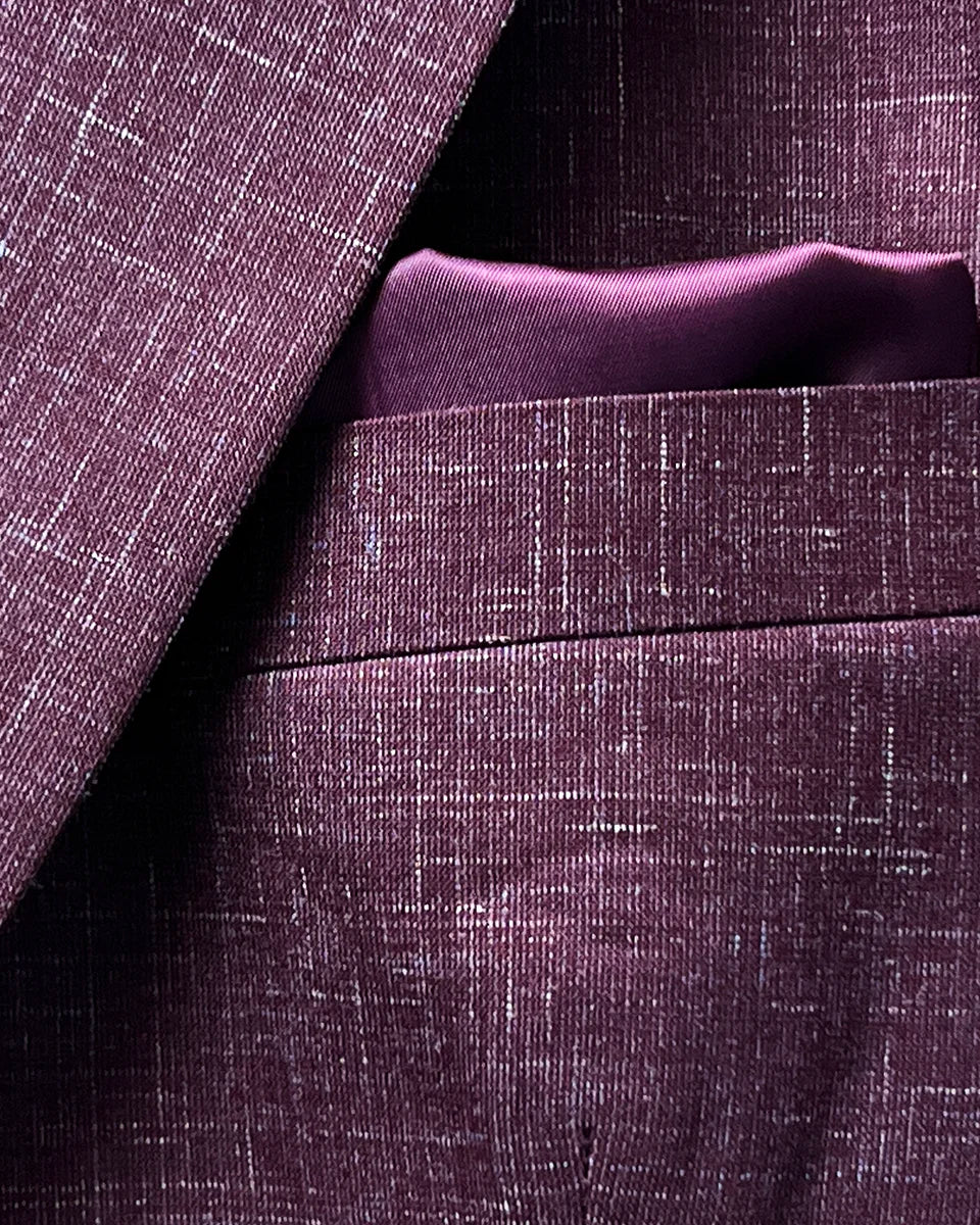 Built-in pocket square feature on a cranberry men's suit by Westwood Hart, adding a touch of elegance to the design.