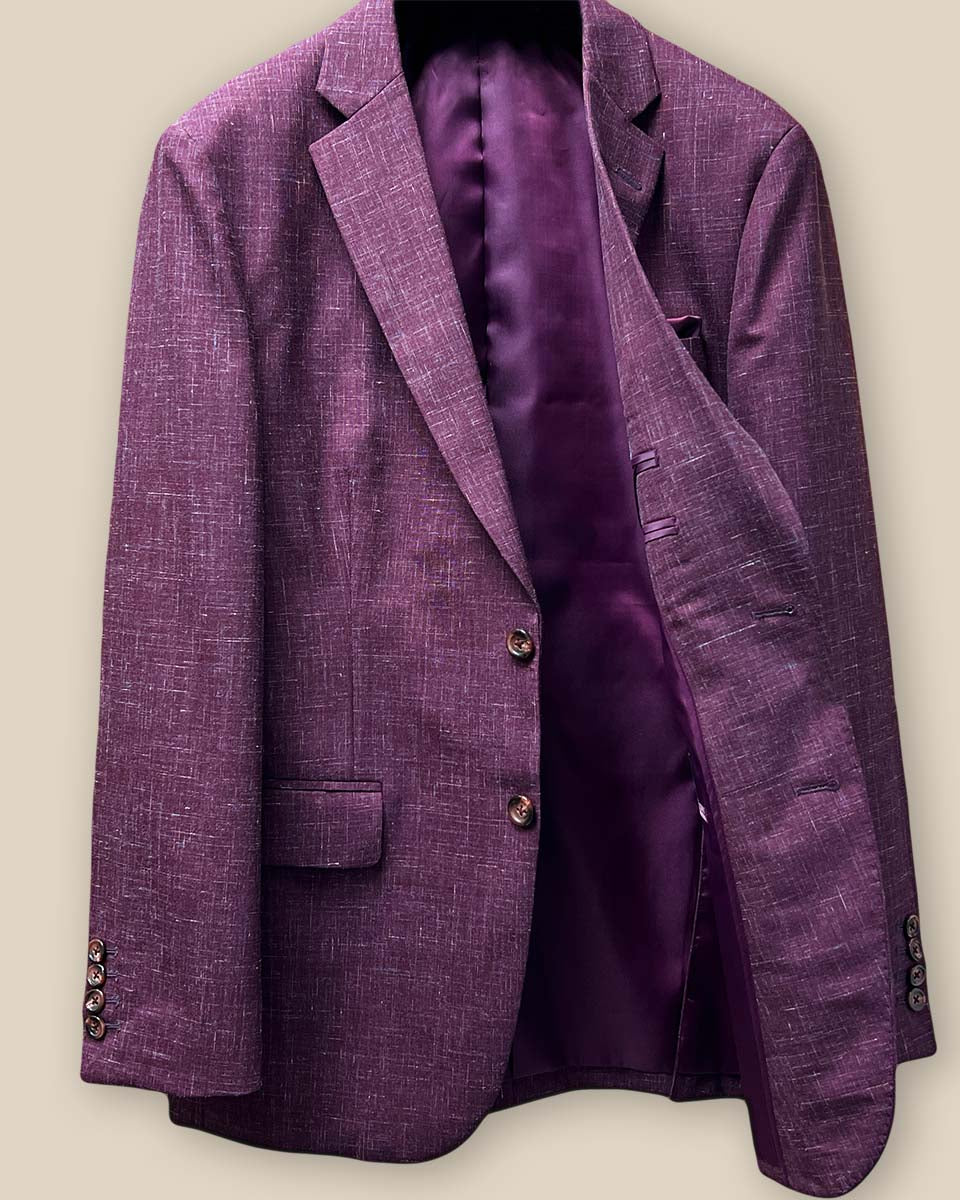 Interior view of the left side of a cranberry men's suit jacket by Westwood Hart, highlighting the maroon bemberg silk lining.