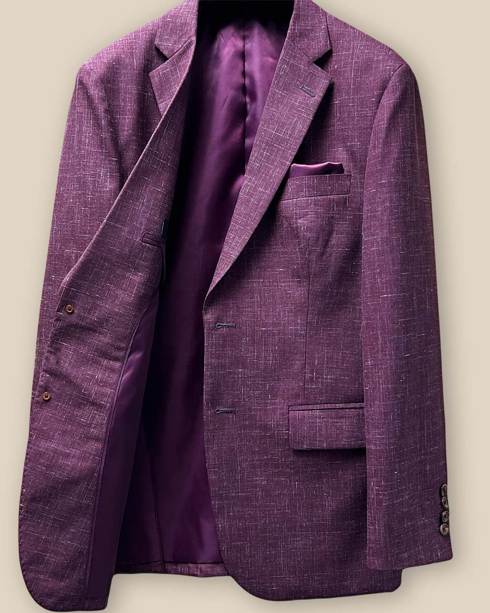 Interior view of the right side of a cranberry men's suit jacket by Westwood Hart, showing detailed stitching and pocket placement.