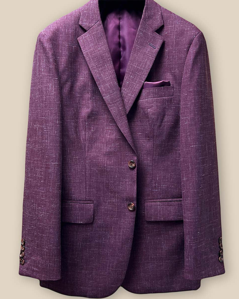 Detailed view of the button panel on a cranberry men's suit jacket by Westwood Hart, featuring burgundy horn buttons.