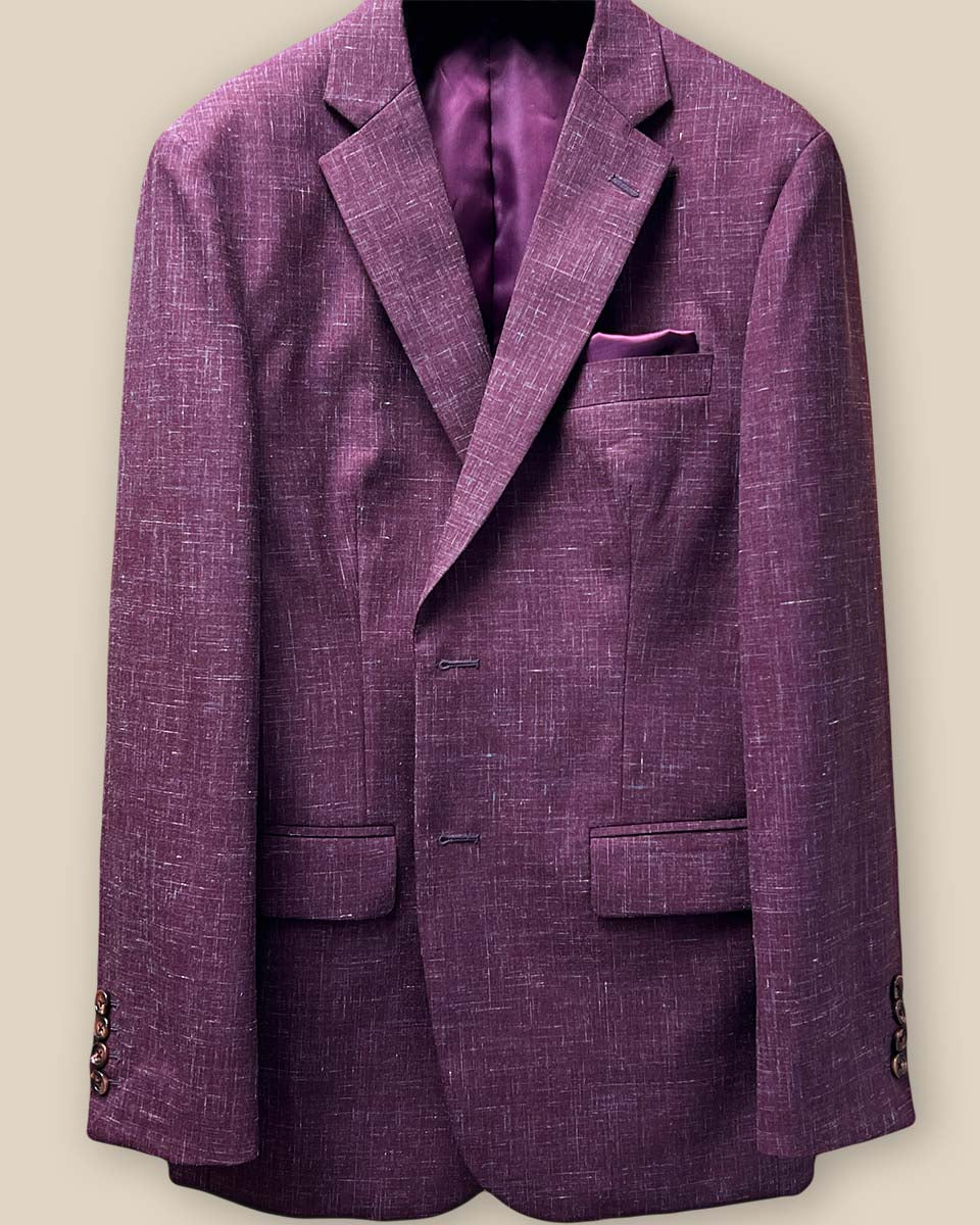 Close-up view of the jacket buttonhole panel on a cranberry men's suit by Westwood Hart, showcasing meticulous craftsmanship.