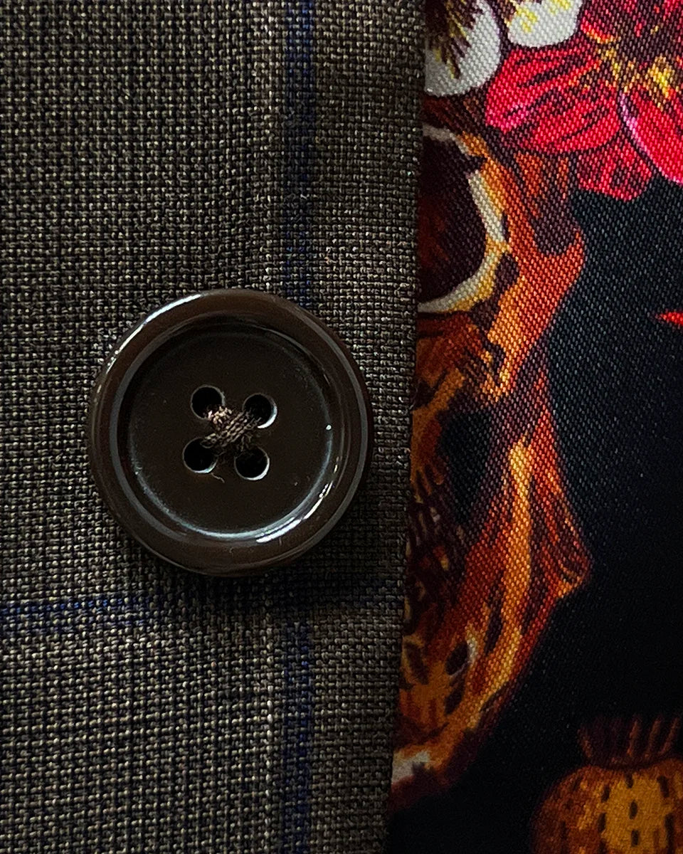 Close-up of brown horn buttons on a chocolate brown sportcoat.