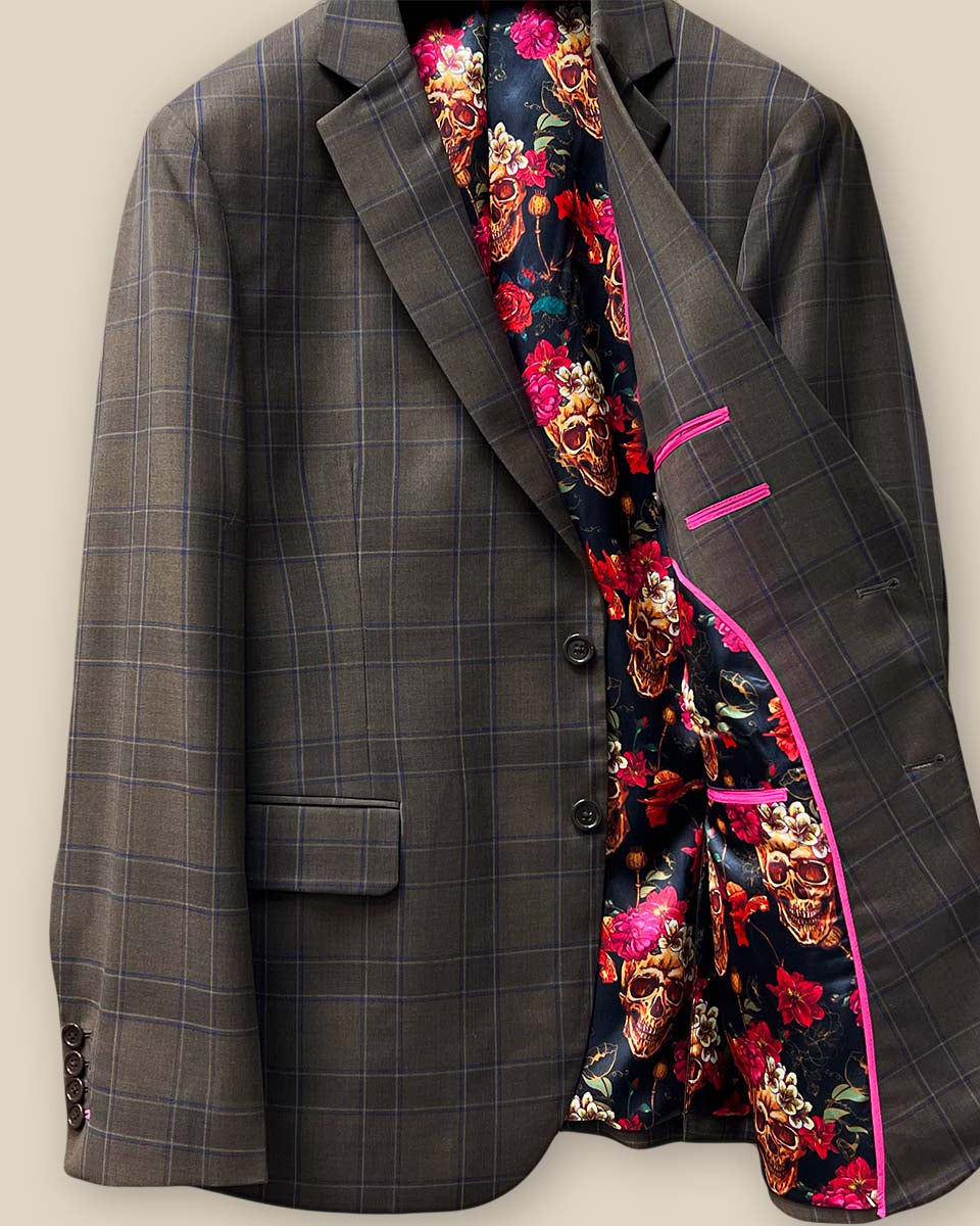 Interior view of the left side of a chocolate brown sportcoat, featuring fuchsia pink contrast trimming.