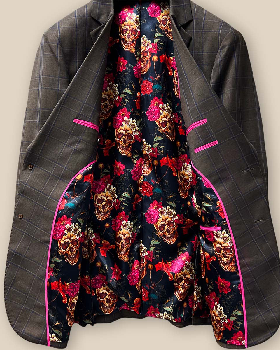 Detailed view of the "Born to Ride" theme lining with skulls and roses on a black background inside a chocolate brown sportcoat.