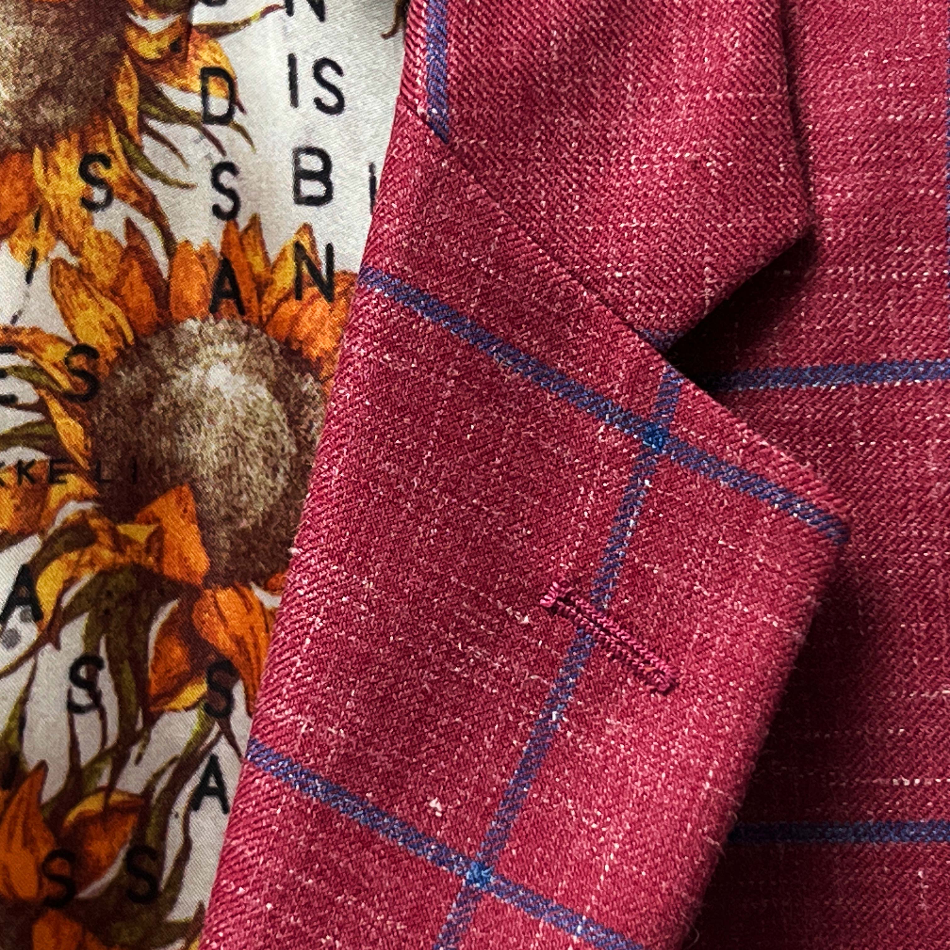 Custom tailored sportcoat in rust maroon, capturing the essence of men's suit trends.