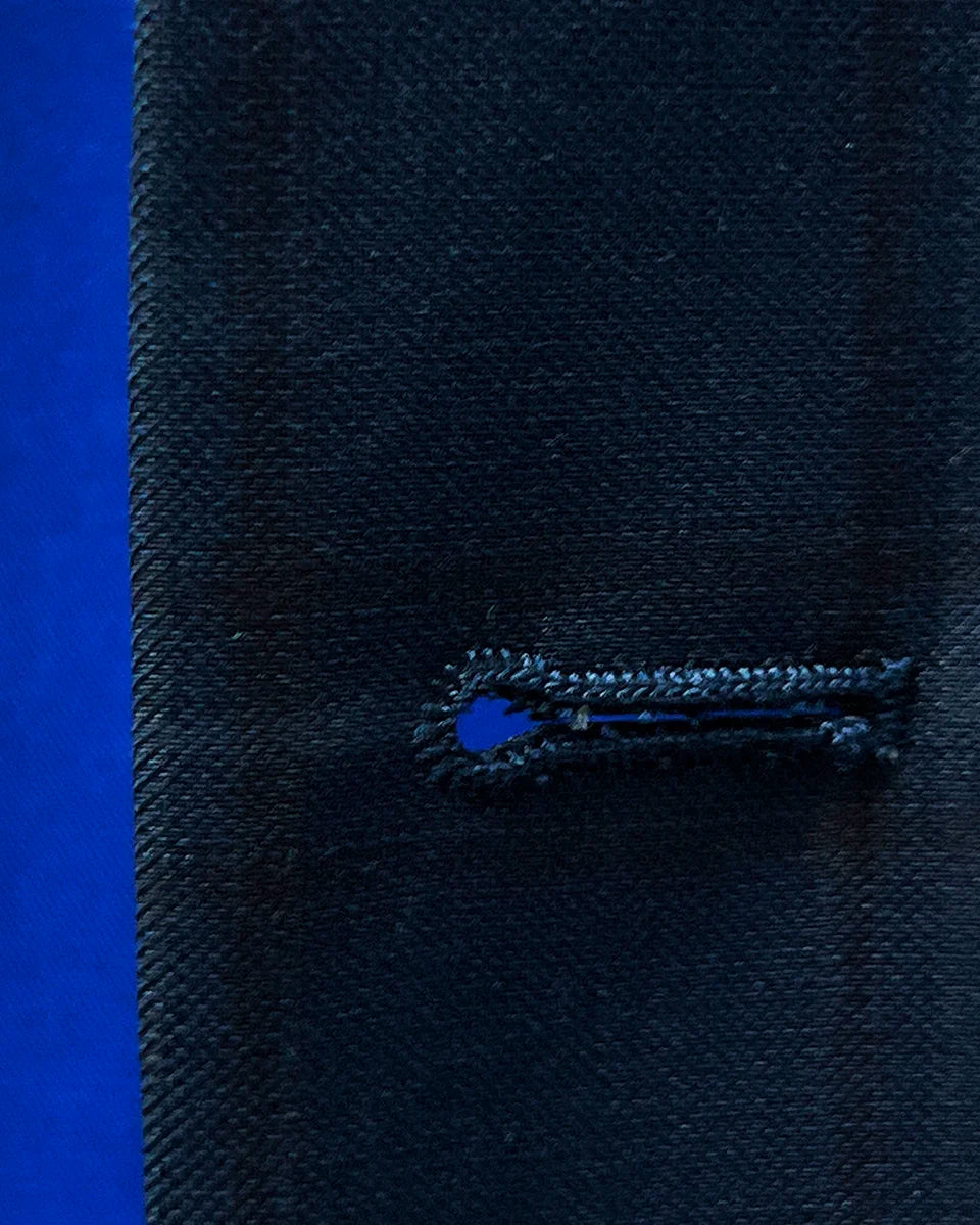 Close-up image showcasing the maroon buttonhole stitching on the sportcoat.