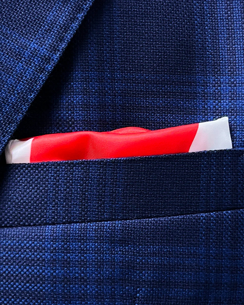 Creative styling option showing the built-in pocket square customization for the blue windowpane Zegna sportcoat with complementary royal blue accent