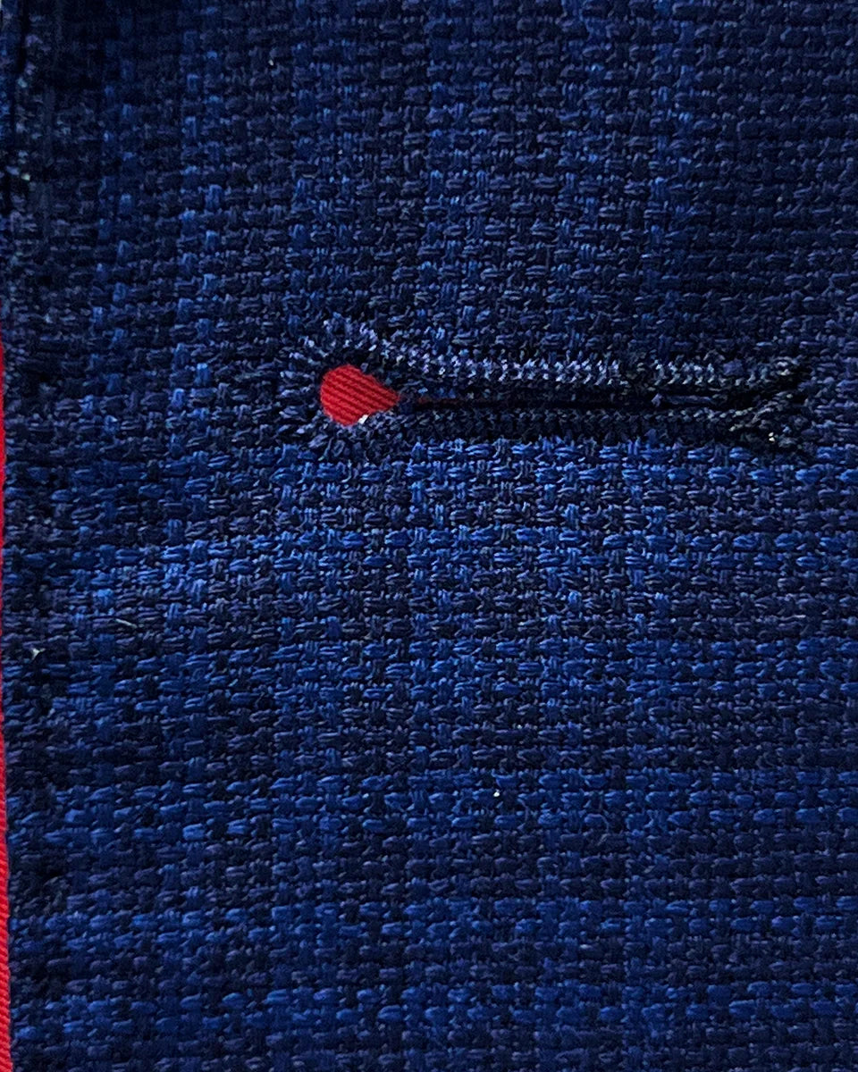 Macro photography of the precision hand-stitched buttonholes demonstrating the superior craftsmanship in this custom Zegna sportcoat