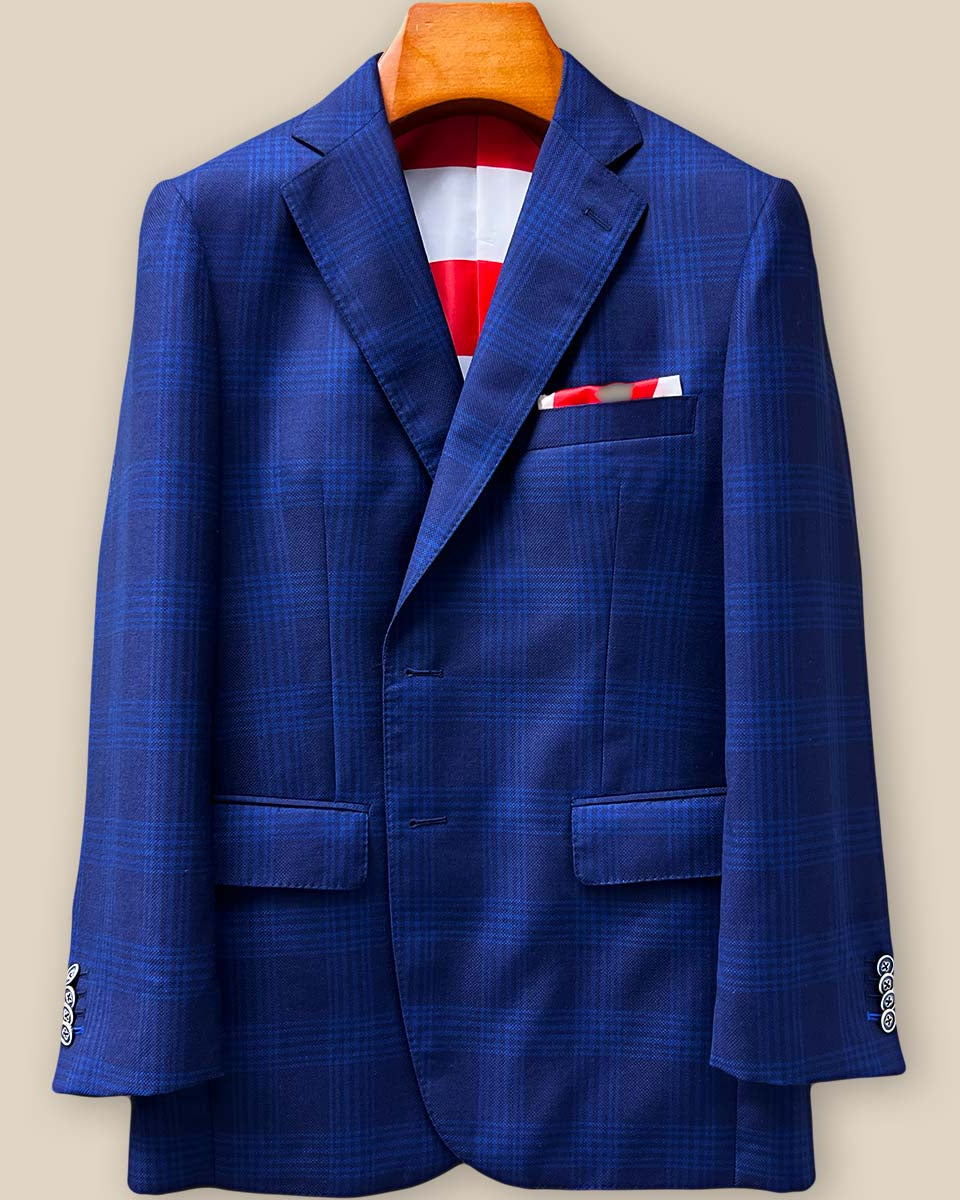 Close-up detail of the premium blue windowpane Zegna sportcoat showing exquisite handcrafted buttonholes with the last one featuring royal blue contrast stitching