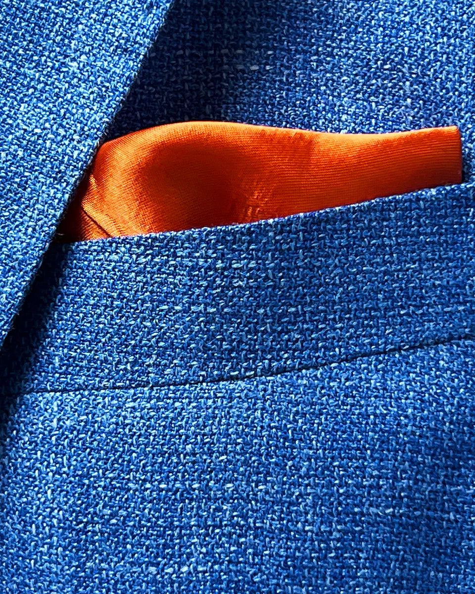 Built-in pocket square detail on the sportcoat, demonstrating the elegant craftsmanship and cohesive design.