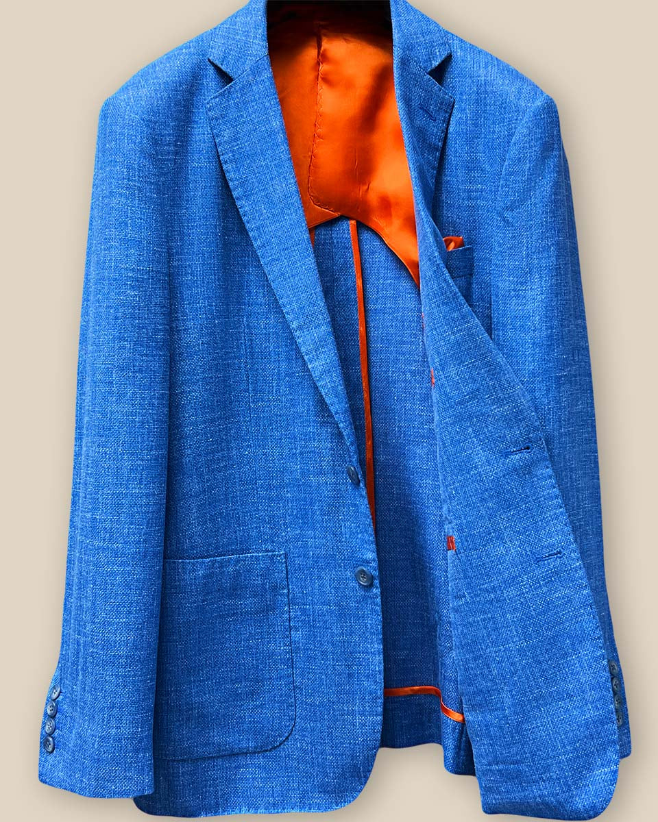 Inside view of the sportcoat's left side, featuring the vibrant bemberg orange lining and the detailed stitching craftsmanship.