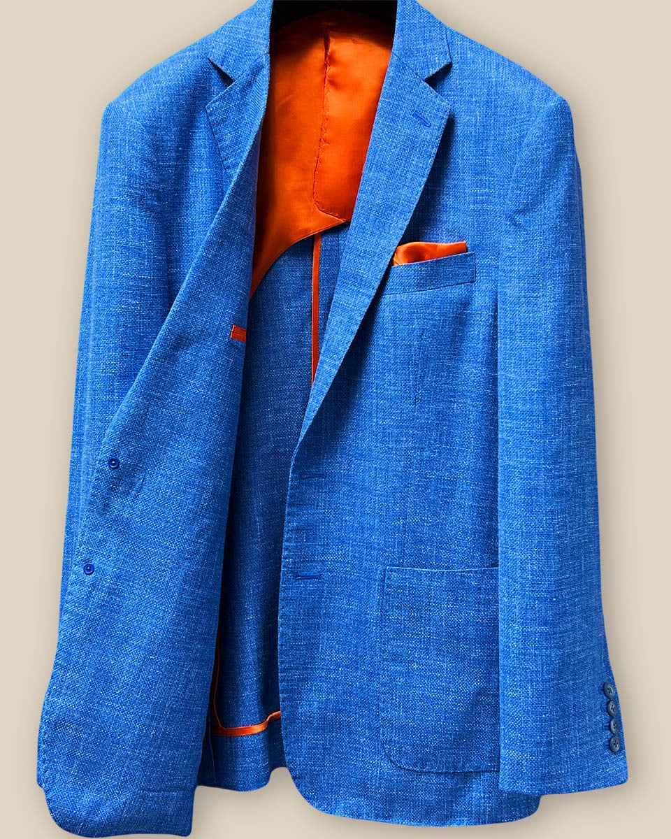 Inside right view of the sportcoat, showcasing the open patch pockets and the smooth bemberg orange lining.