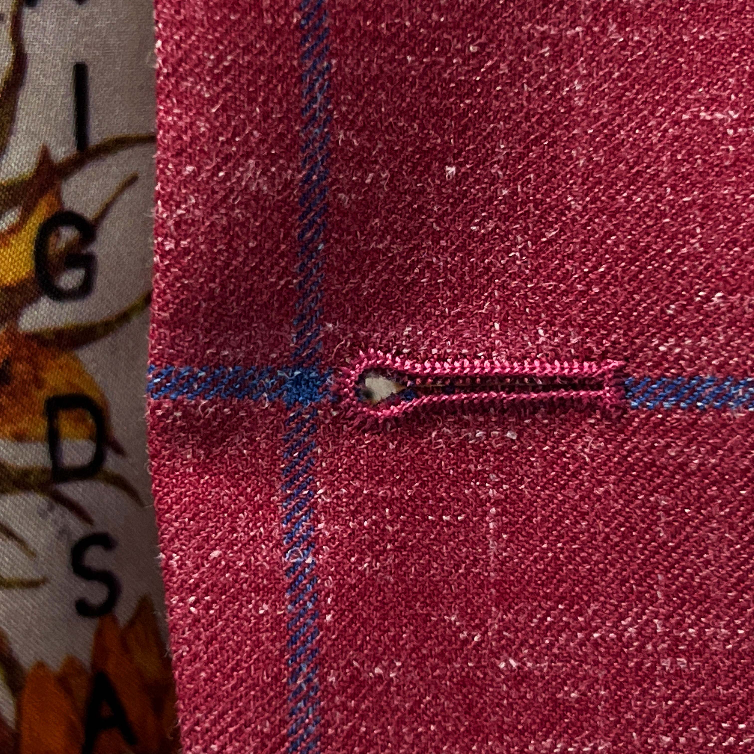 Fashionable suit trend for 2023, rust maroon sportcoat with a touch of royal blue.