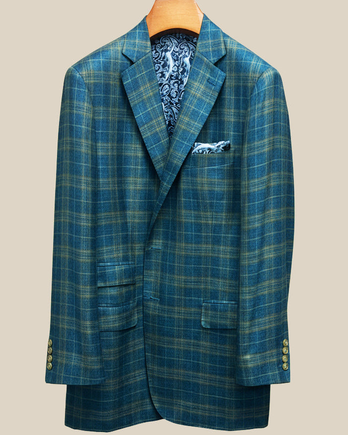 Close-up view of deep teal green multi check suit jacket showing contrast olive green accent buttonhole with hand-finished stitching detail